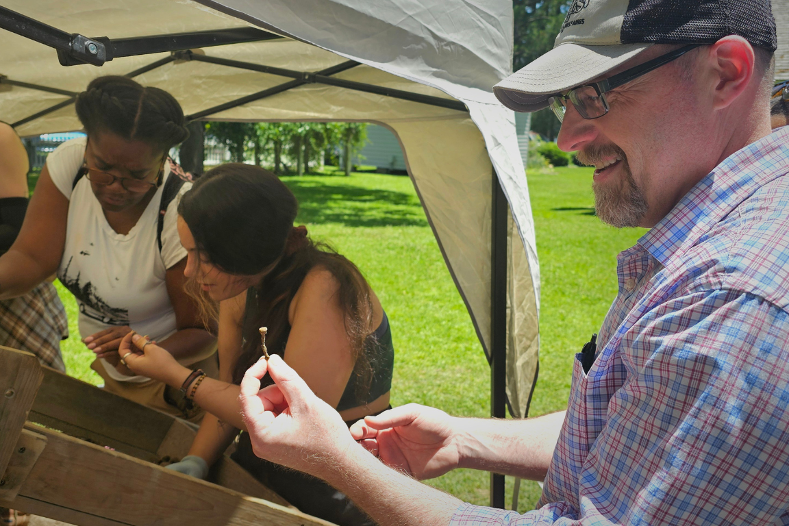 A250 Freedom Fellows participate in an archaeology dig.