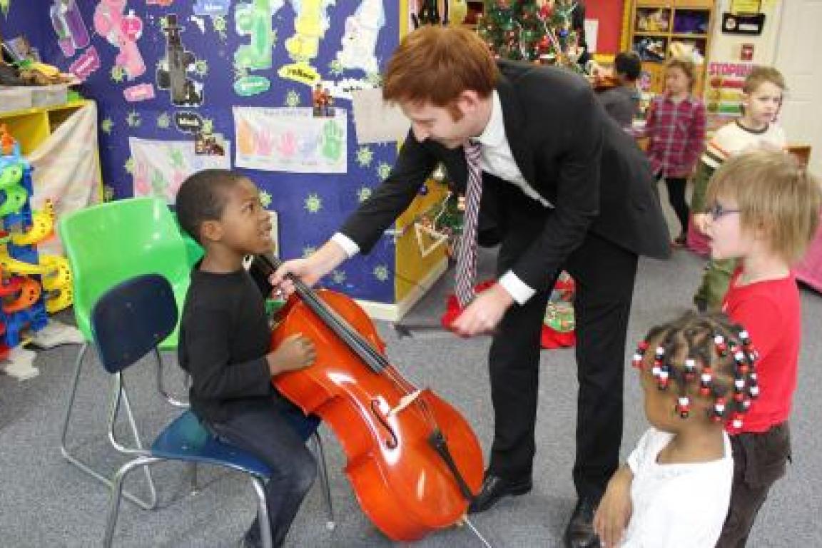 Musician shows a child a violin