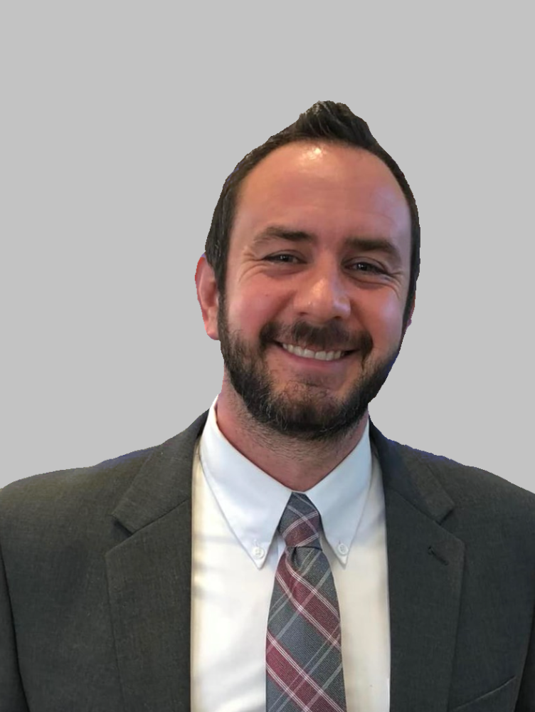 a white man in a suit smiles at the camera