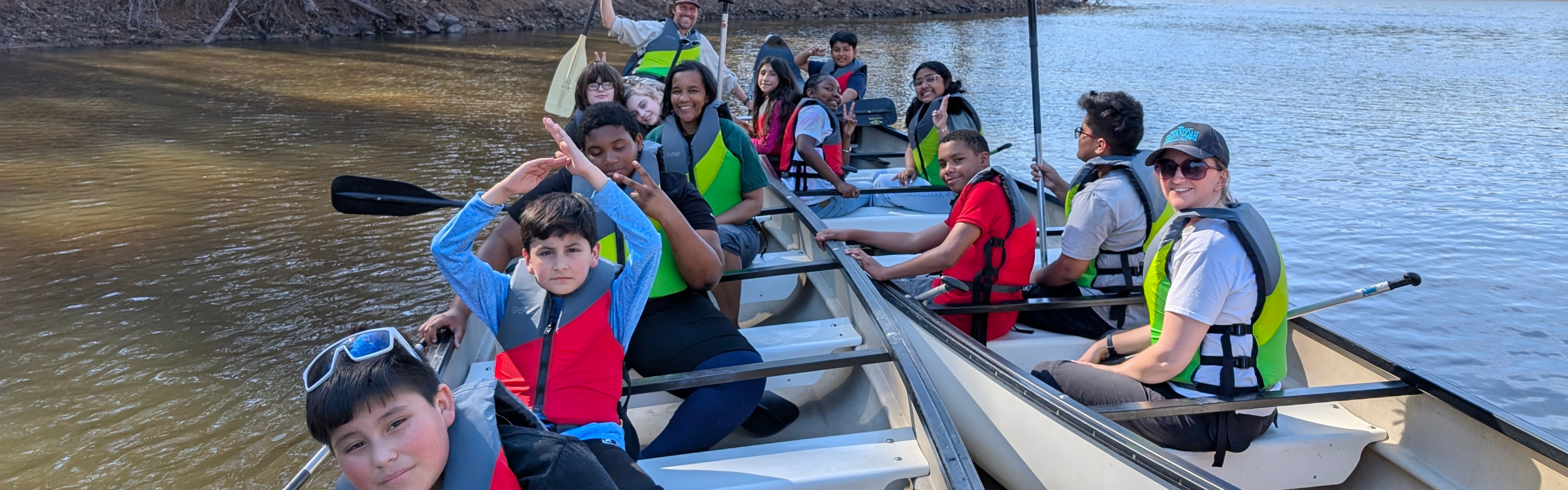 Students paddle in two big canoes 