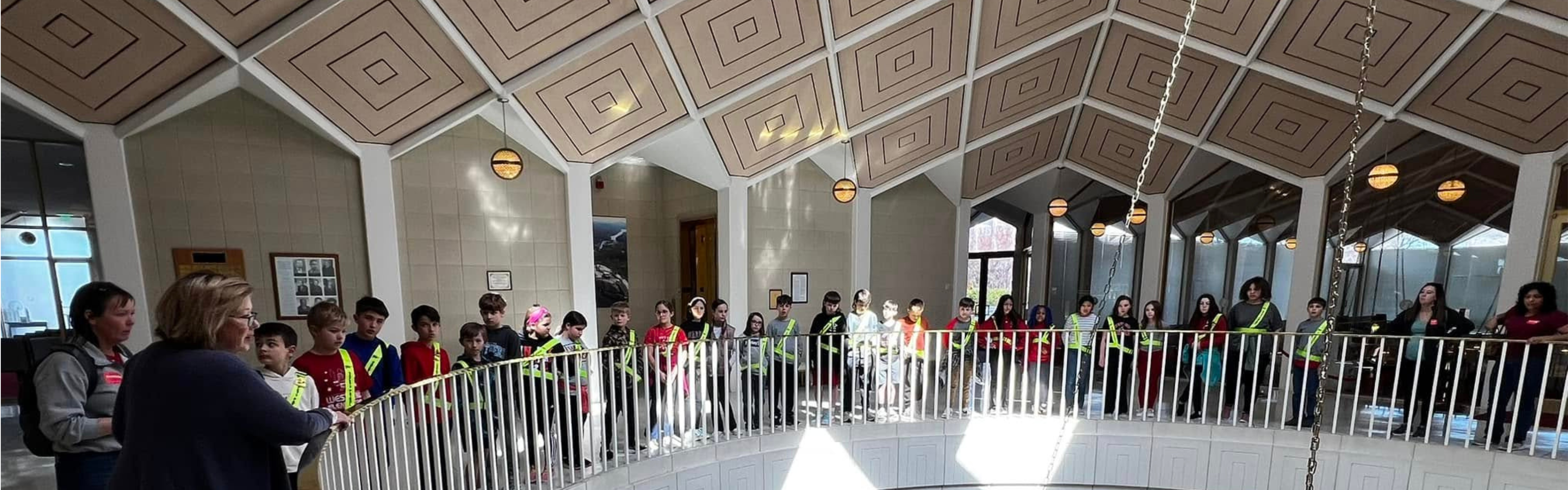 Students look over banister in modern building 