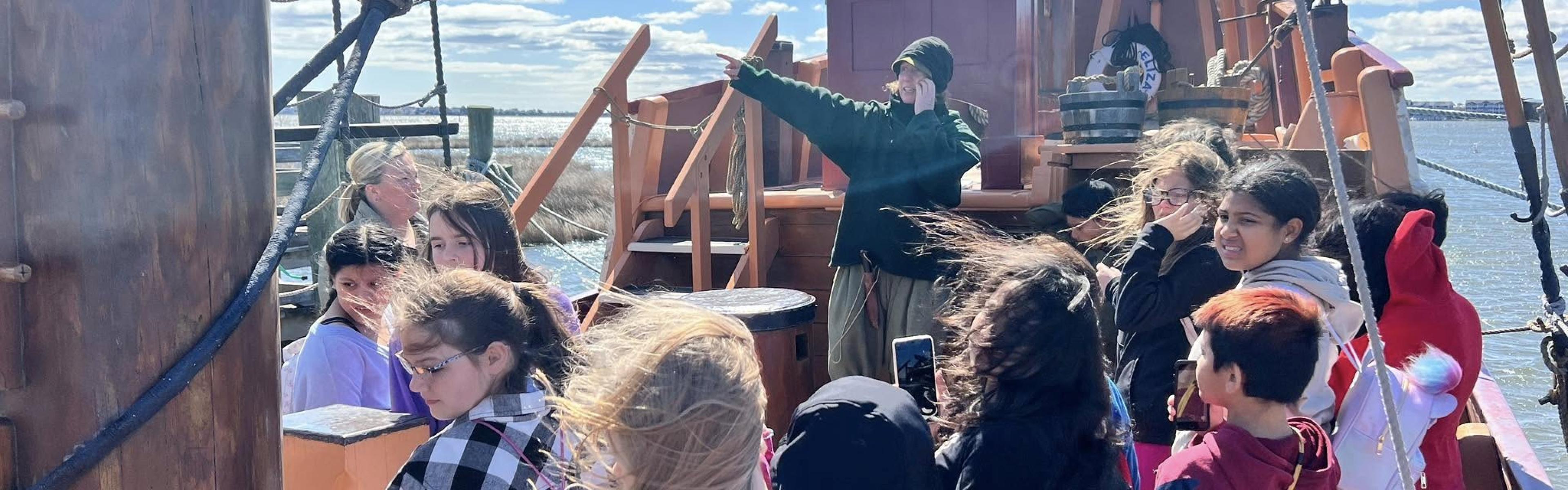 Students onboard a colonial sailing ship 