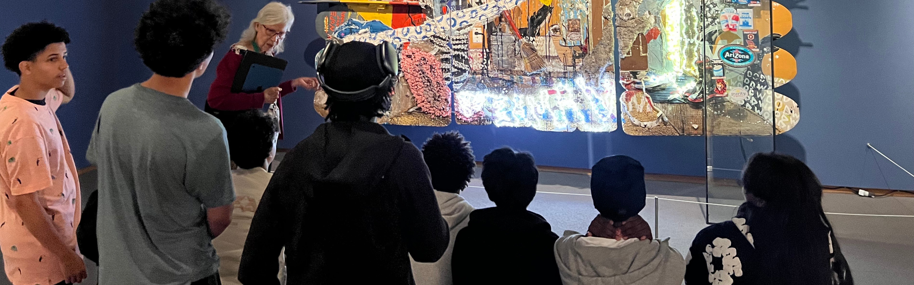 Students learn from docent about art 