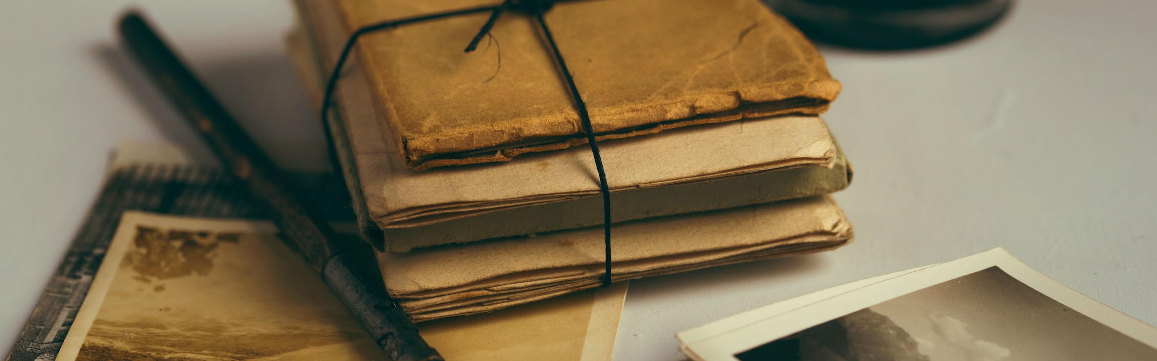 old books and sepia toned photographs on a tabletop