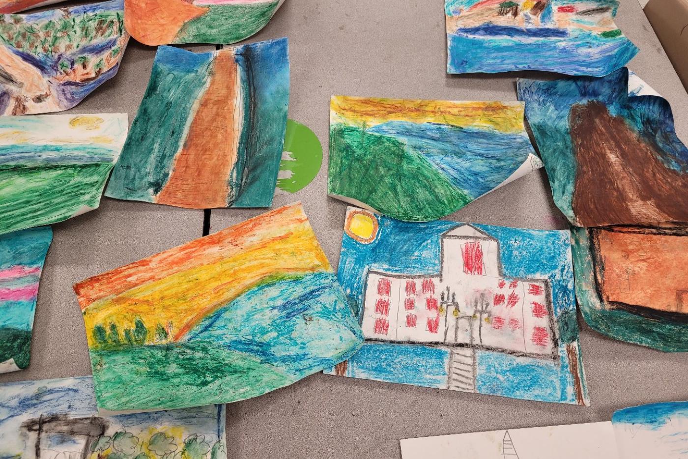 colorful paintings laid out on a table