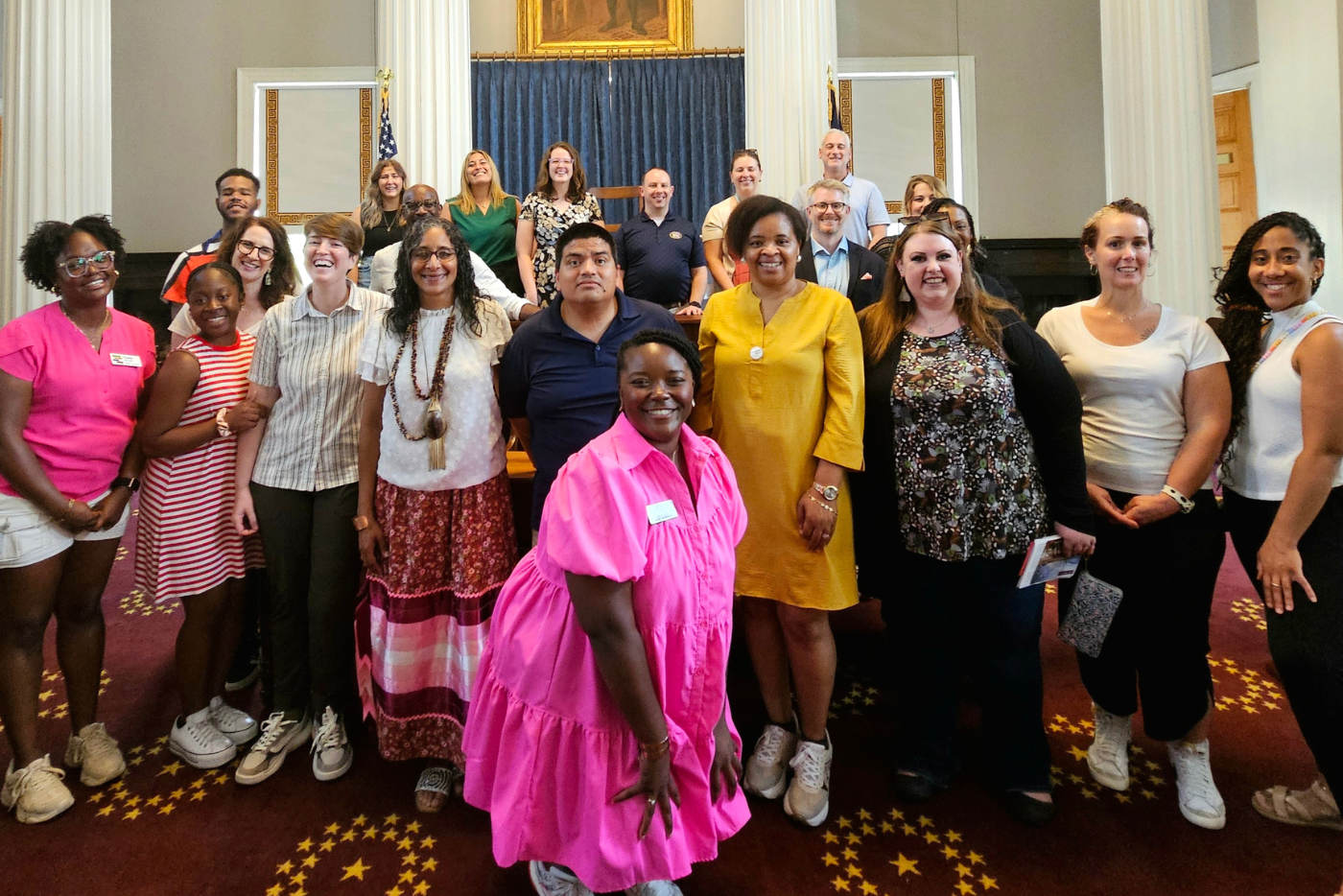15 teachers pose in the State Capitol Building