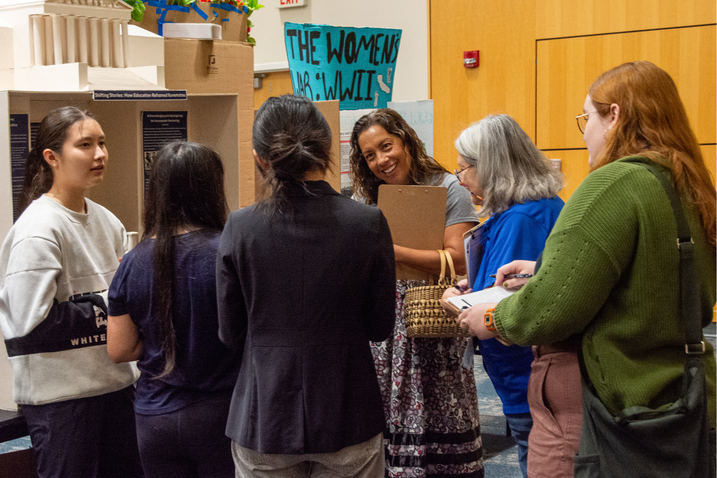 Judges interview a group of exhibit students from Cary Academy