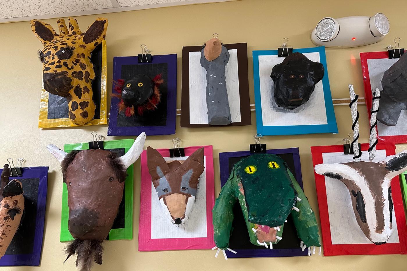 a variety of animals masks made from paper mache