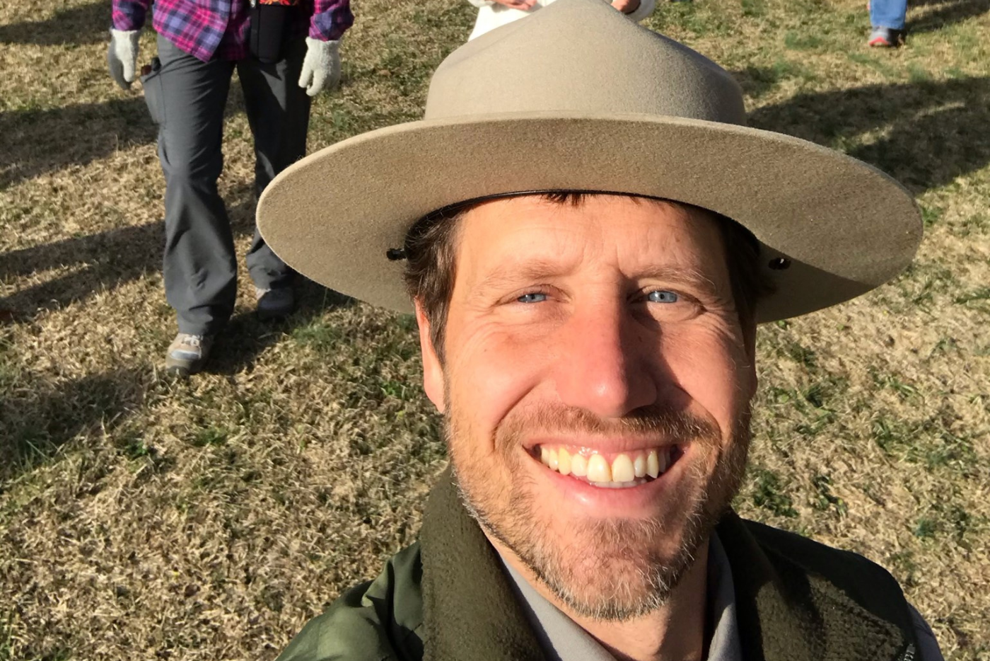 Sean Higgins smiles while hiking.