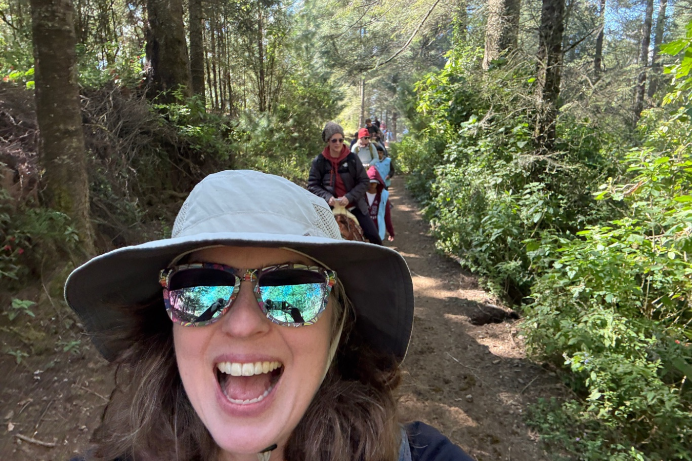 Teachers ride horses on a trail in Mexico.
