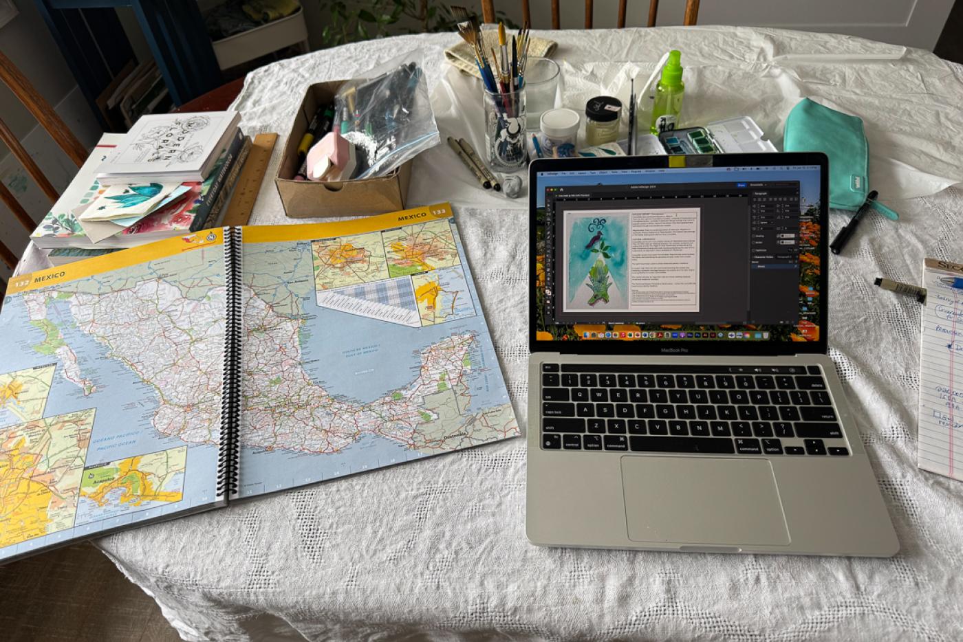 An educator's workspace is covered with maps and resources on Mexico.