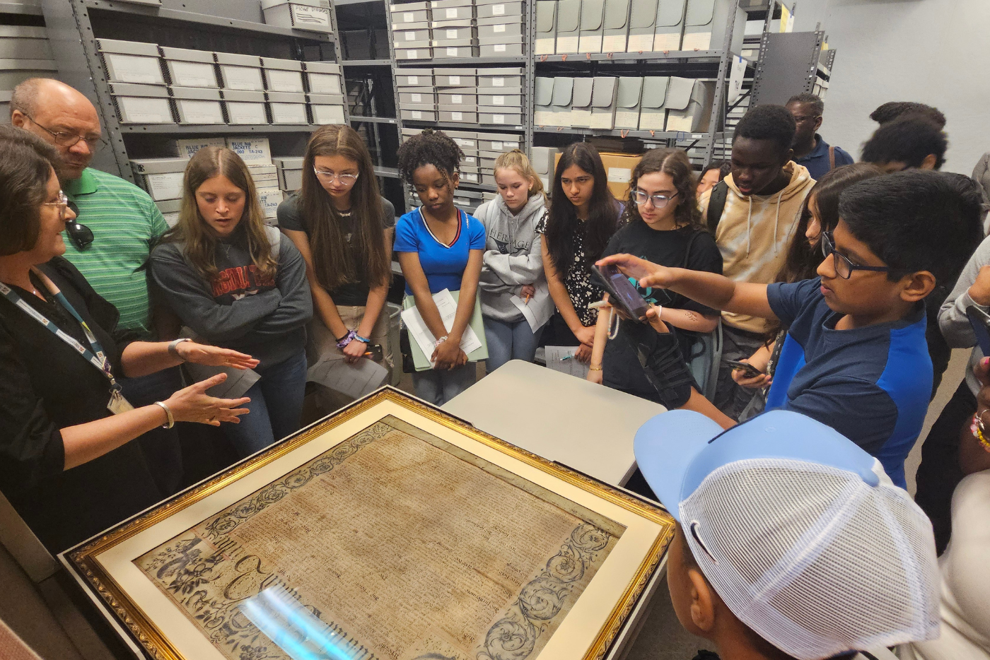 Students explore the Carolina Charter during a vault tour at the State Archives.
