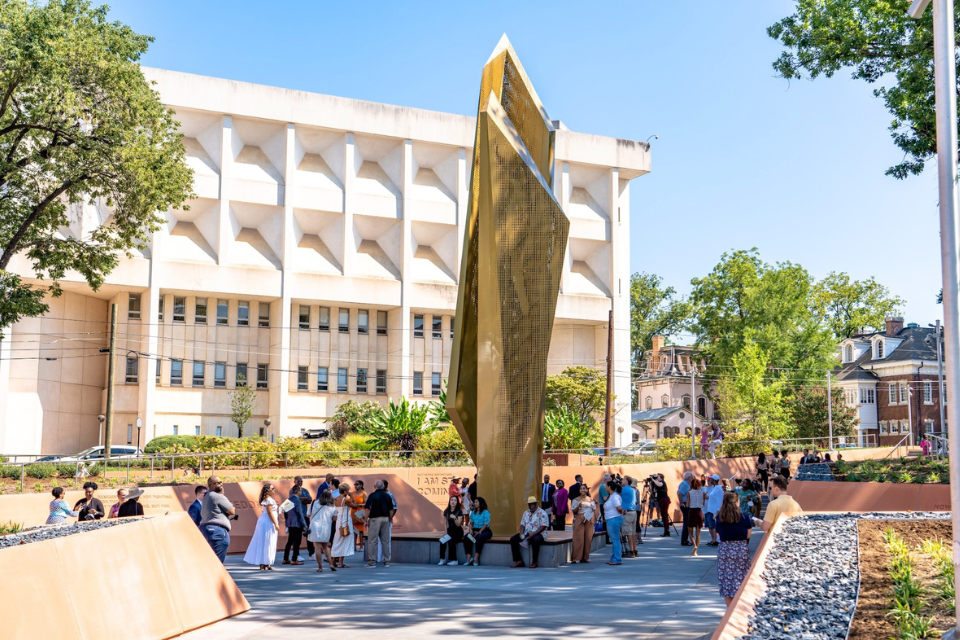 People gather around the monument at the NC Freedom Park