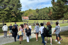 Students walk towards a 19th century plantation house