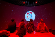 Students view an earth stimulation on an imax screen
