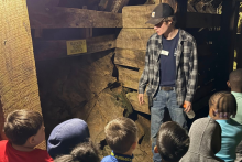 Tour guide explains mining ore to students