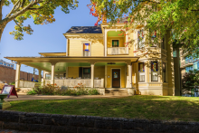 Yellow two-story house with covered porch, the home of Thomas Wolfe