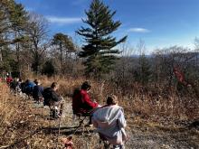 Students study leaves and make drawings while overlooking Gorges State Park views