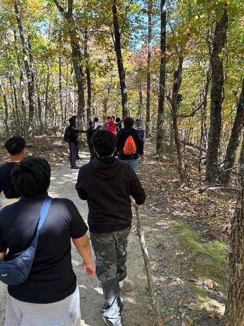 Students hike along a trail.