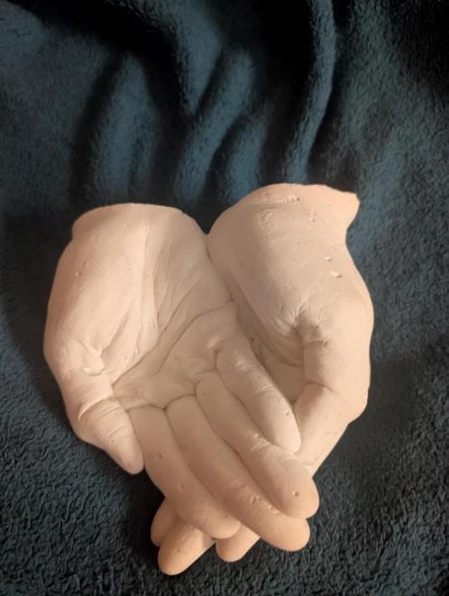 Photograph of a ceramic model showing two life-sized cupped hands
