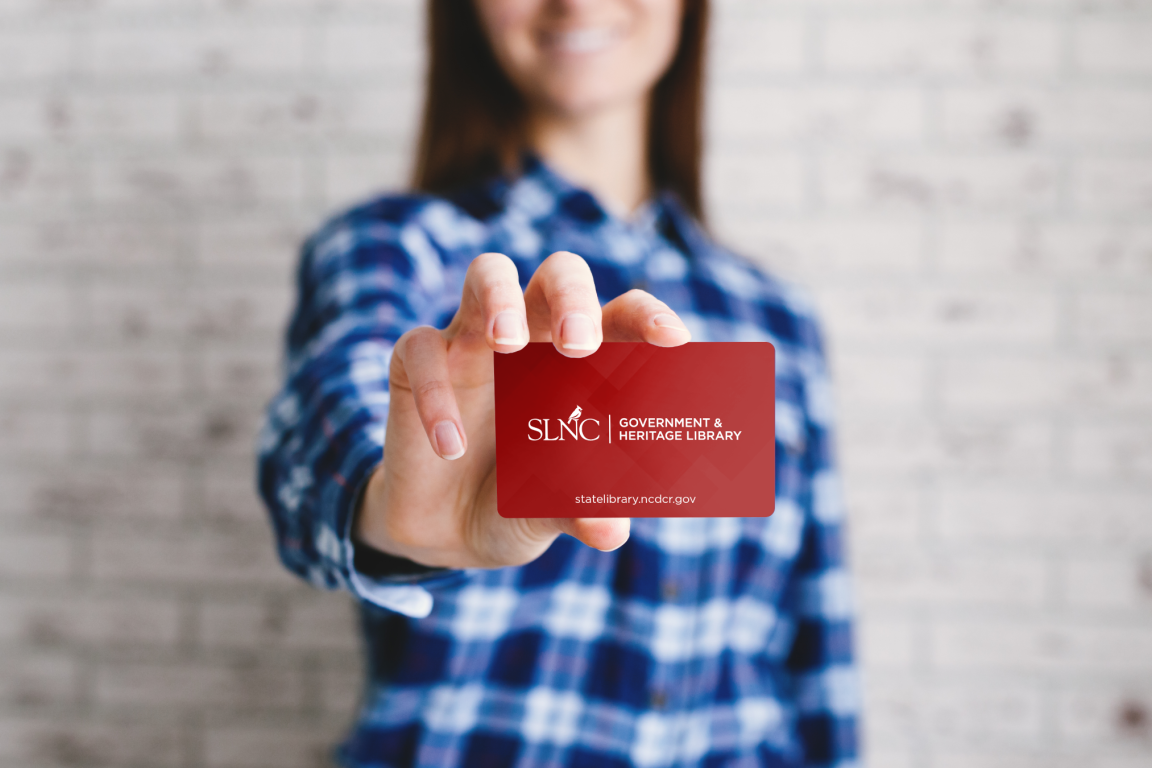 A woman showing a library card