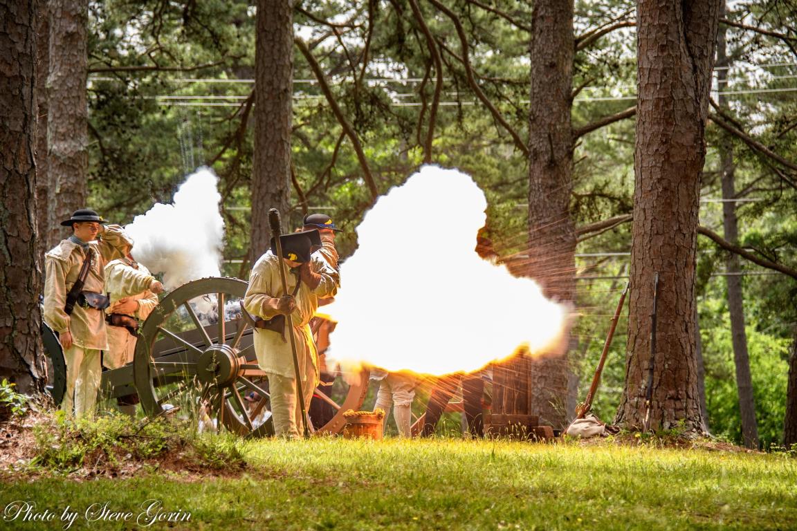 Alamance Battleground to Host ‘Fight for the Backcountry,’ the Battle of Alamance Re-enactment May 16. Image of re-enactors firing a cannon.
