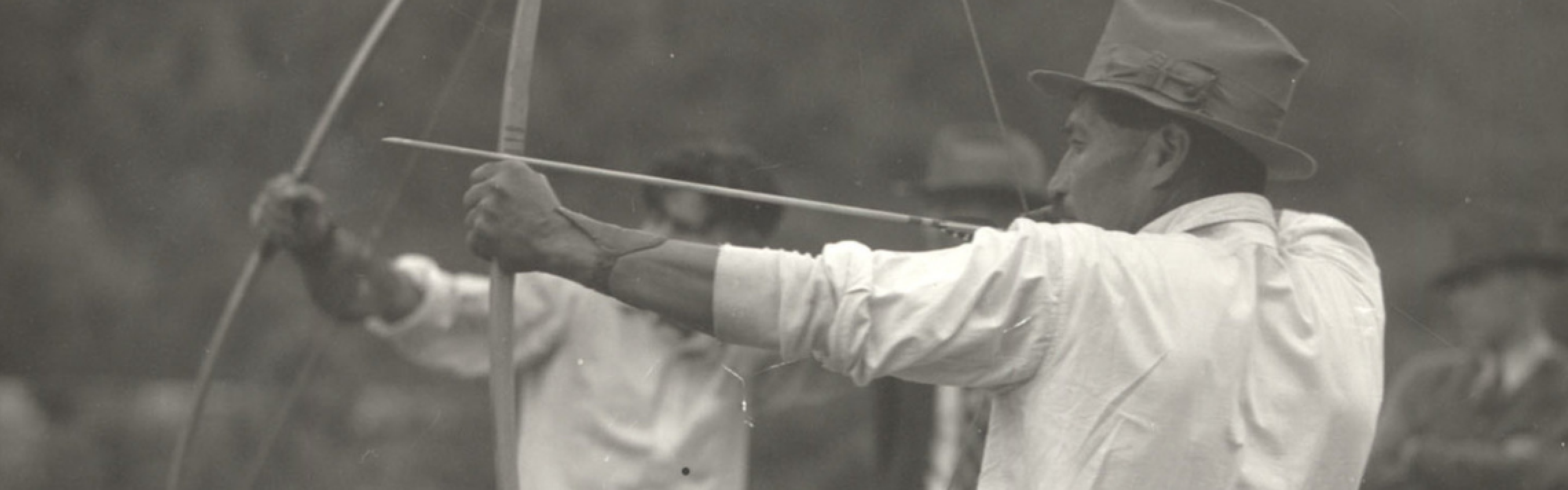 Black and white image of Native Americans shooting bows