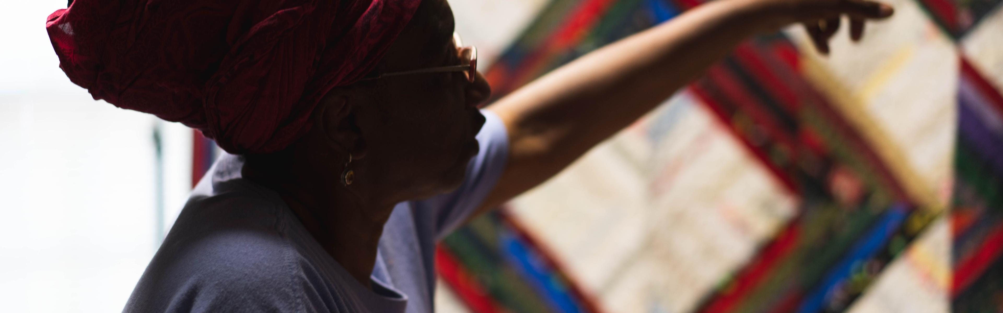 Woman pointing at a quilt