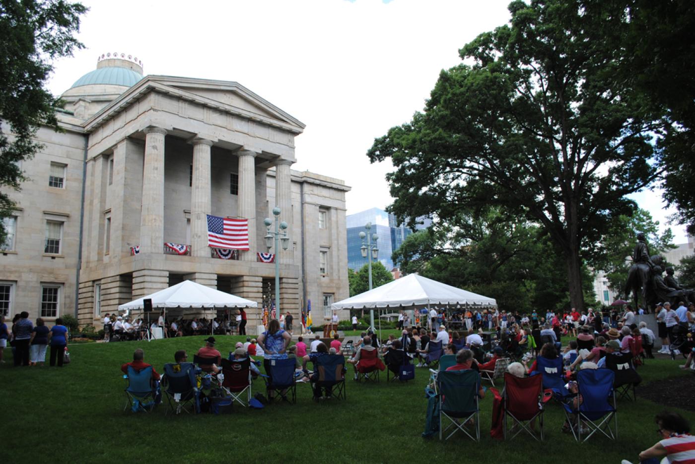A large gathering of people outside the North Carolina State Capitol Building.
