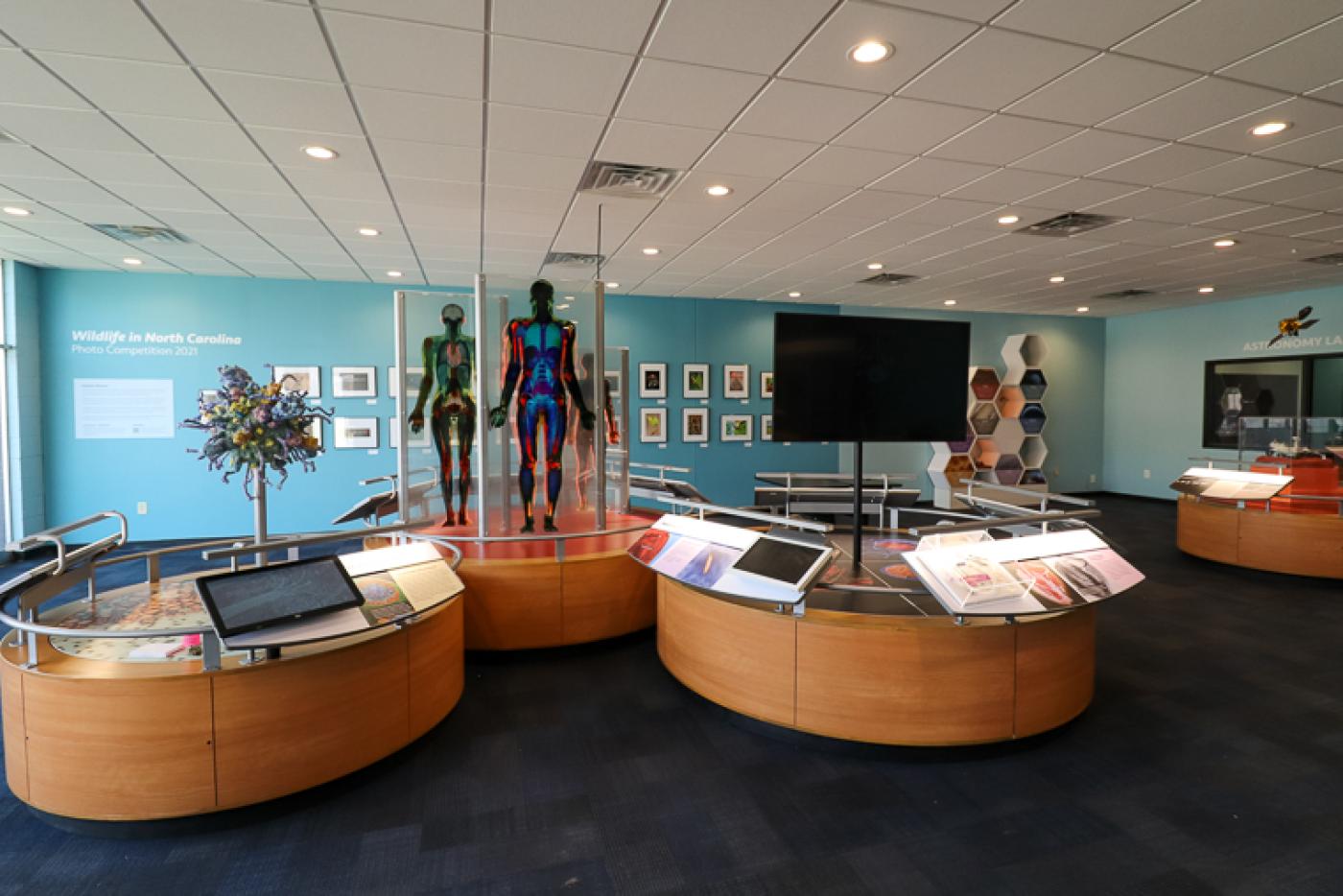 A science exhibit full of displays of human mannequins, screens, and various information booths.