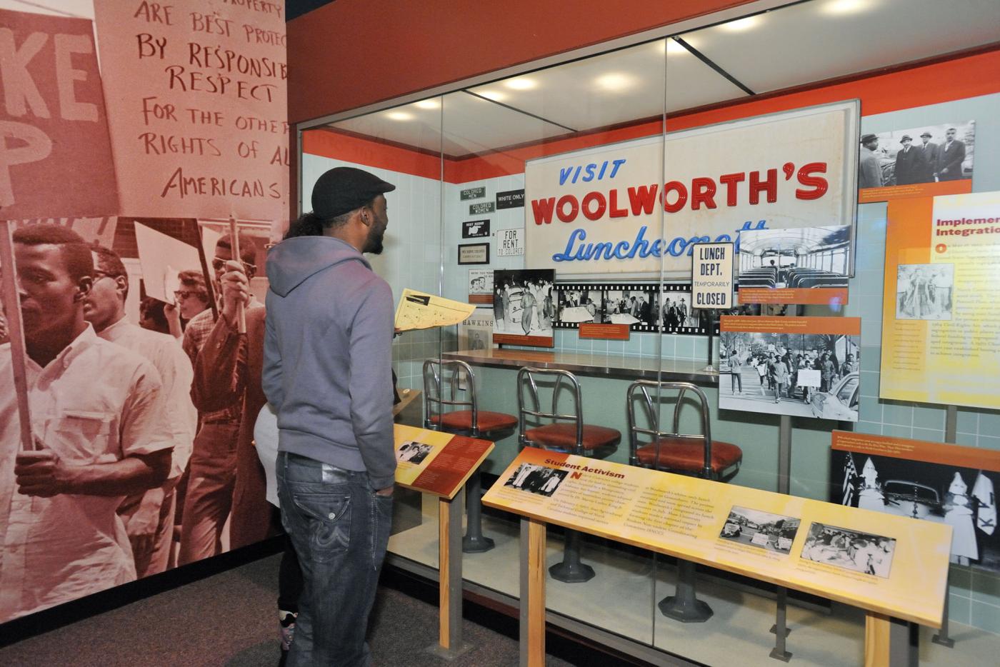 A person viewing a Civil Rights exhibit dedicated to Woolworth's Luncheon.