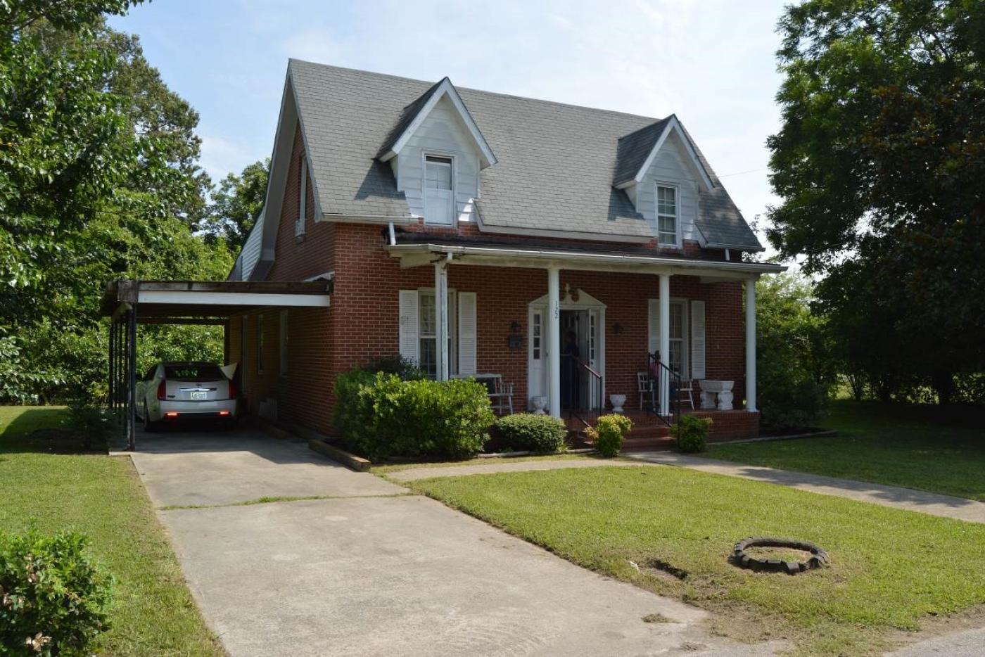 A house with a car parked in the driveway.