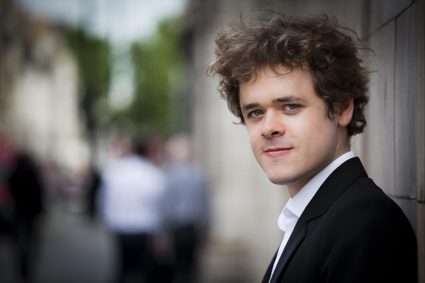 Benjamin Grosvenor smiling towards the camera.