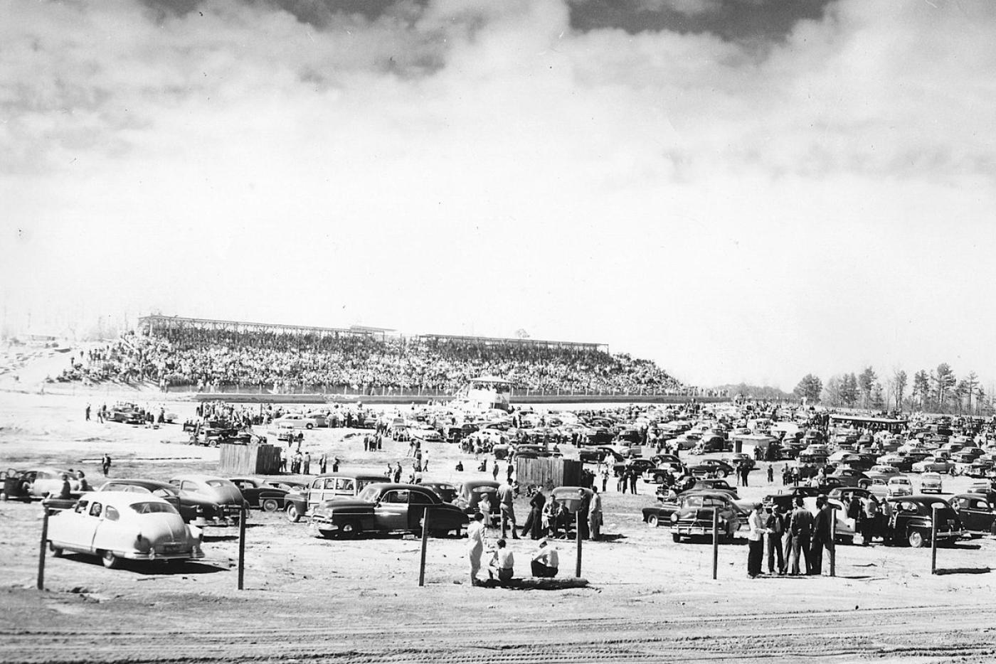 A black and white photo of various race cars.