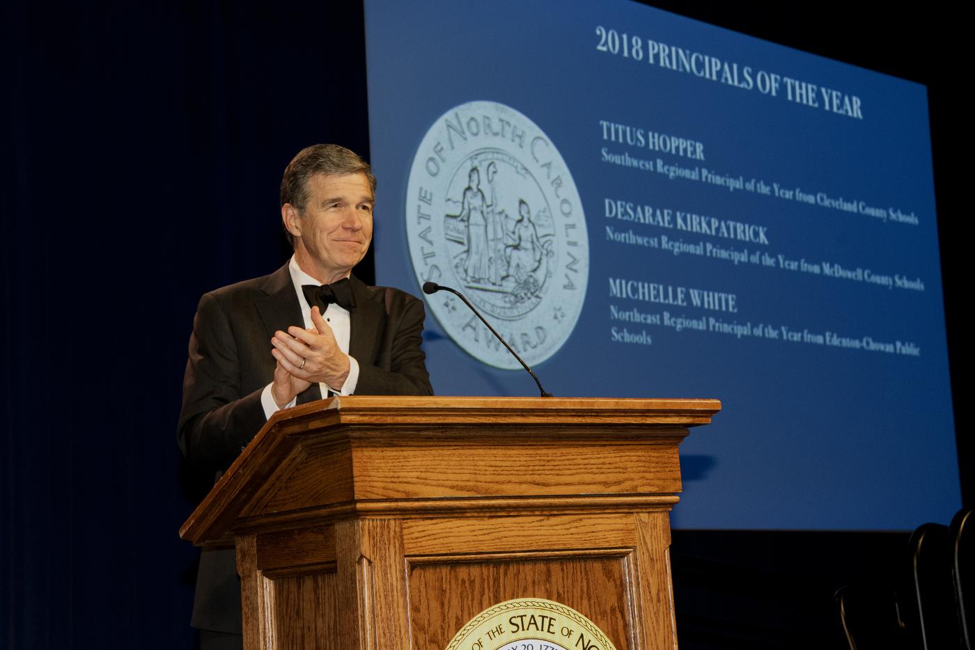 Governor Cooper speaking at a podium.