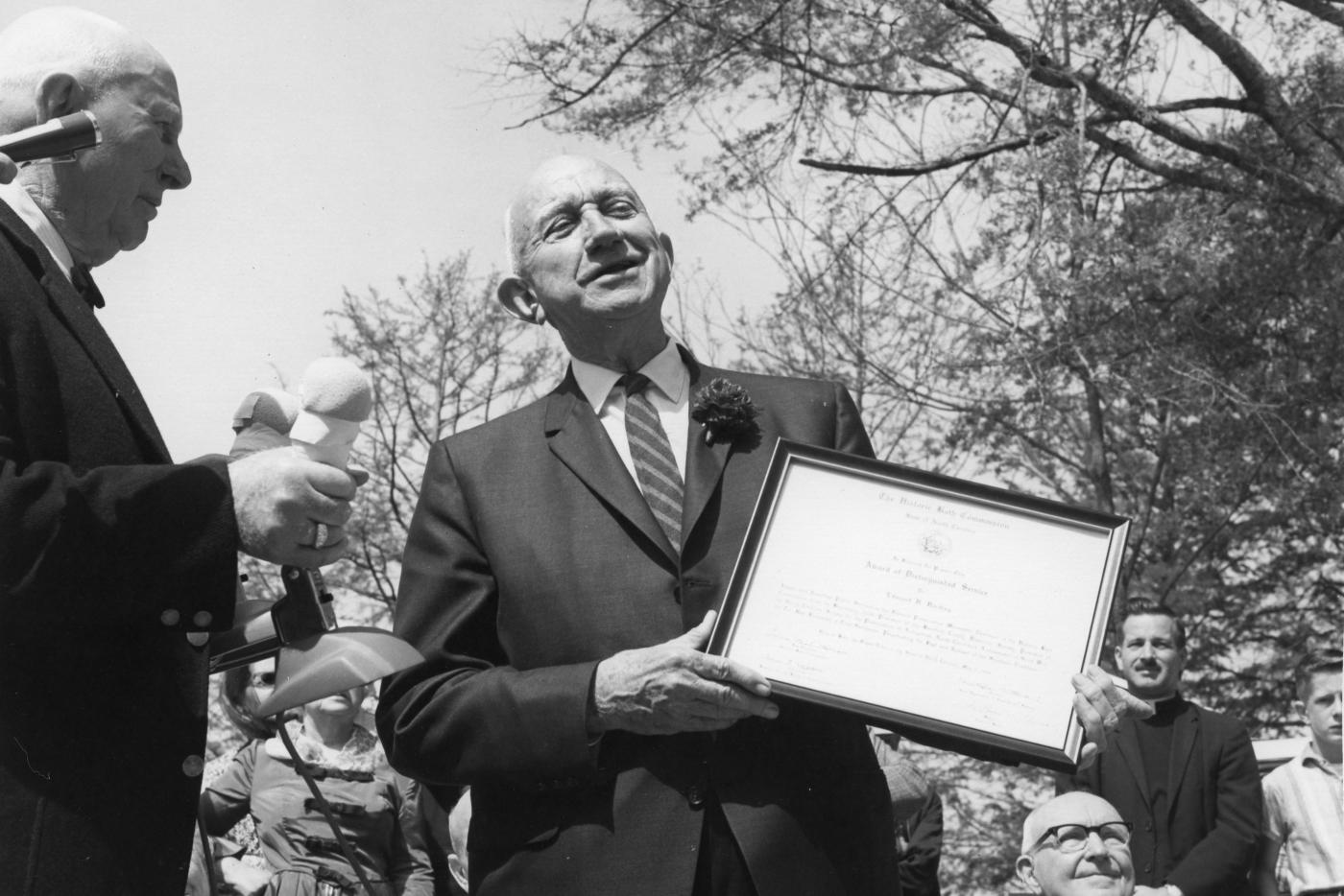 Edmund Harding holding a certificate.