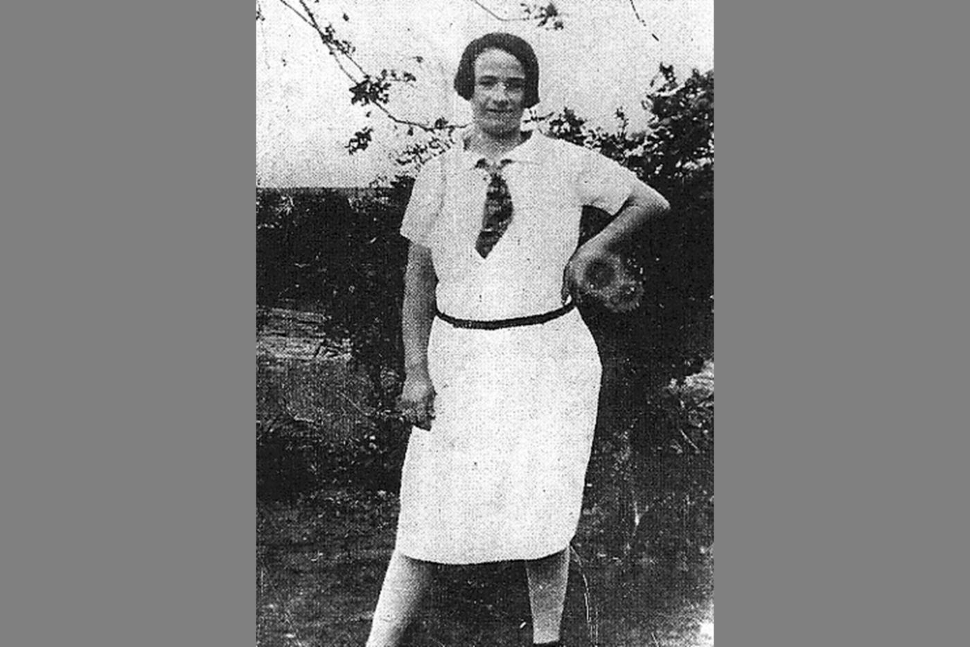 A photographic of a woman, Ella May Wiggins, wearing a white top and skirt, with a tie.