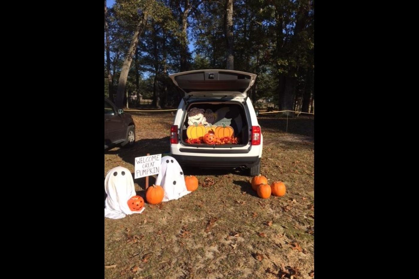 The back of a car filled with Halloween decorations.