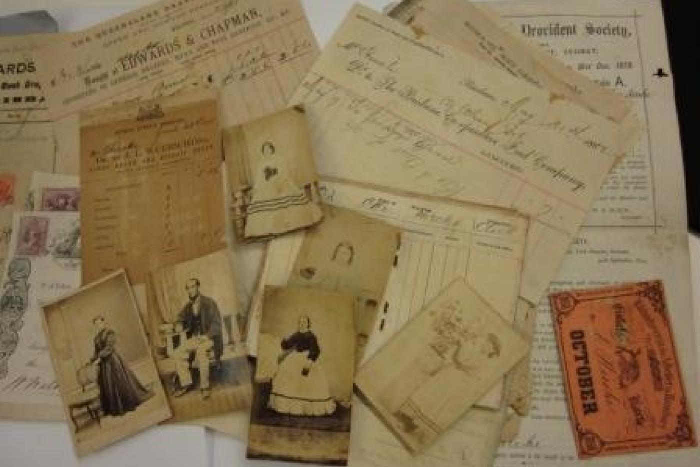 Various documents and photos spread across a table.