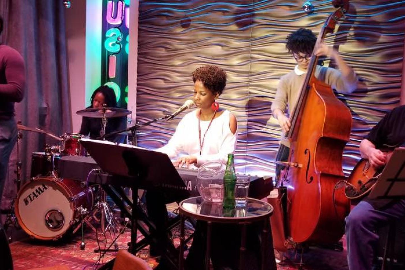 Lydia Salett Dudley and her band performing on stage.
