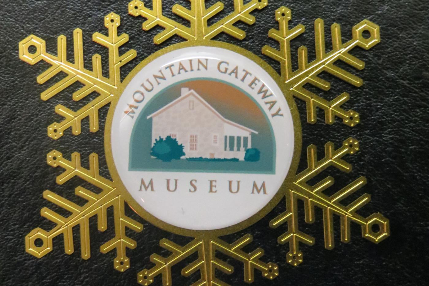 A snowflake ornament with the Mountain Gateway Museum logo on it.
