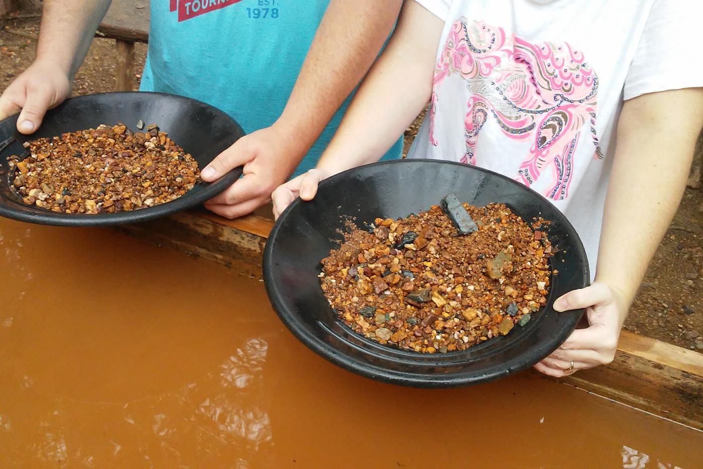 Two children panning for gold.