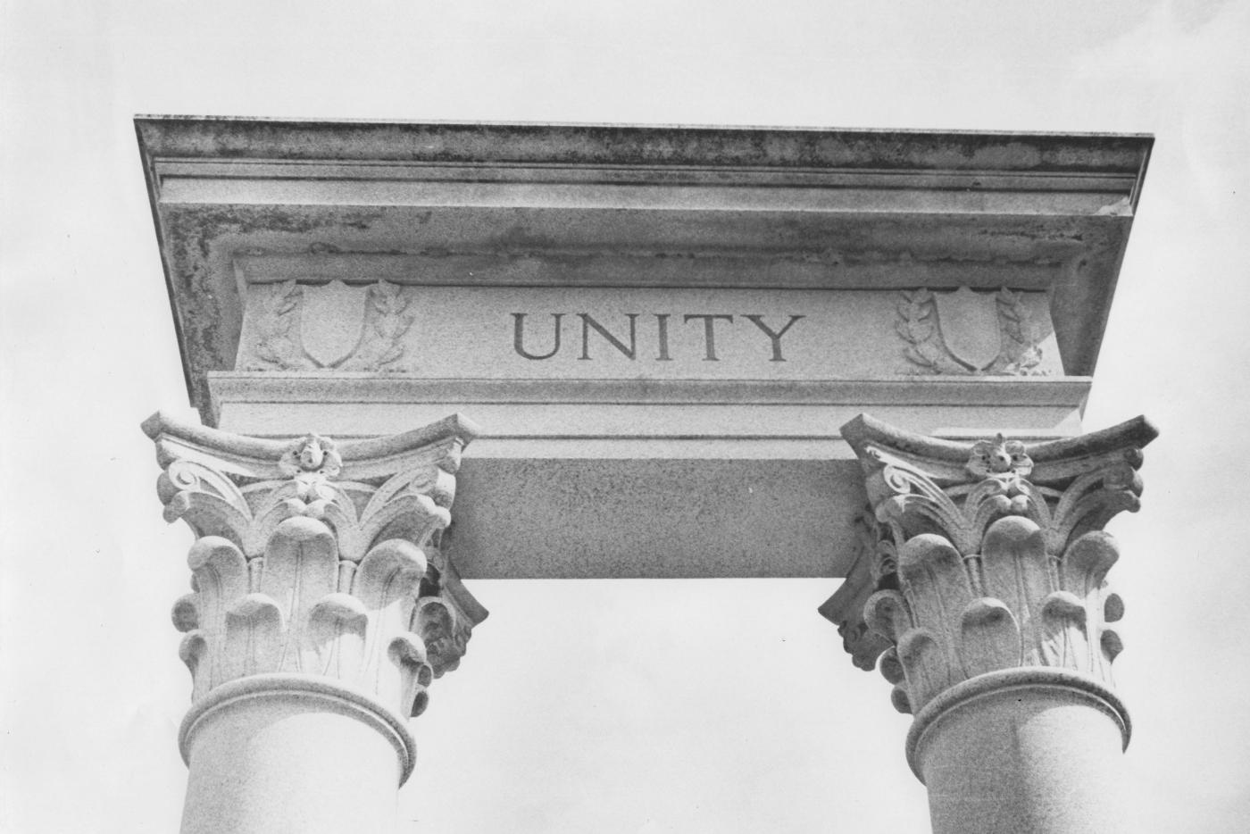 Two pillars holding up a block with the word "Unity" on it.