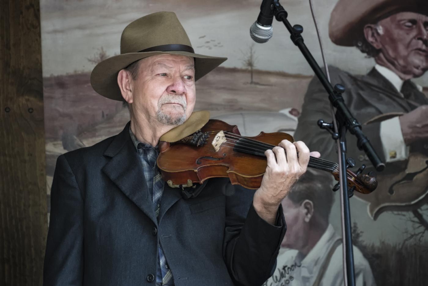 Bobby Hicks performing with a violin on stage.