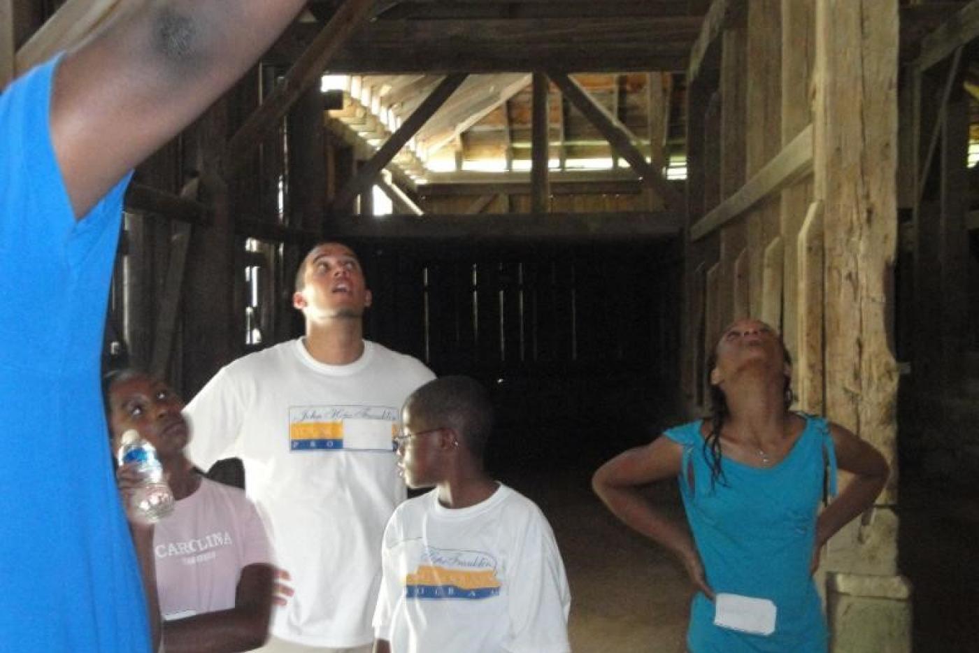 Tourists visiting a barn at Historic Stagville.