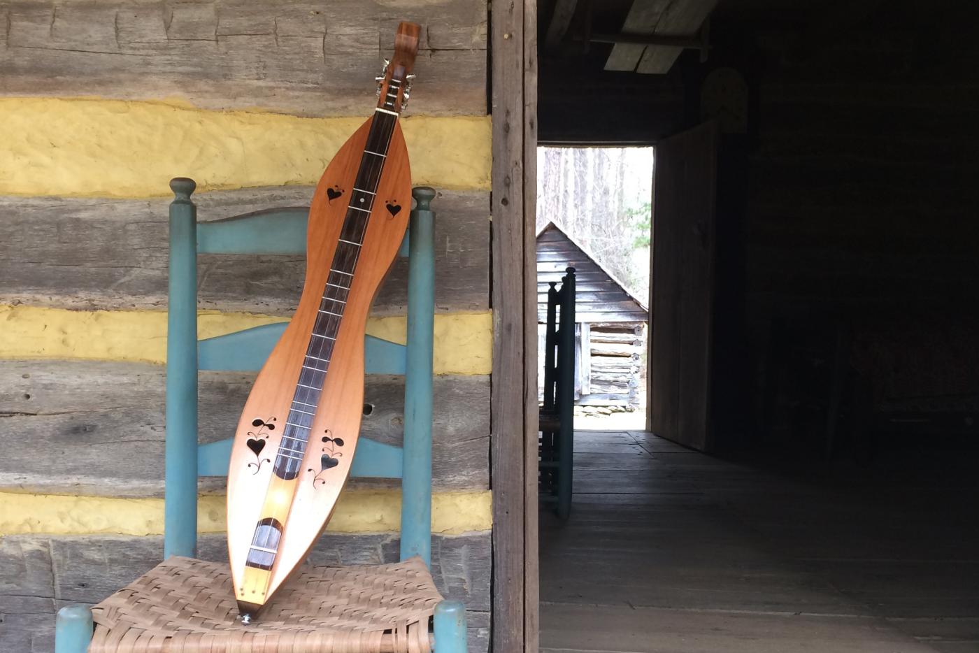 A dulcimer placed on a chair.