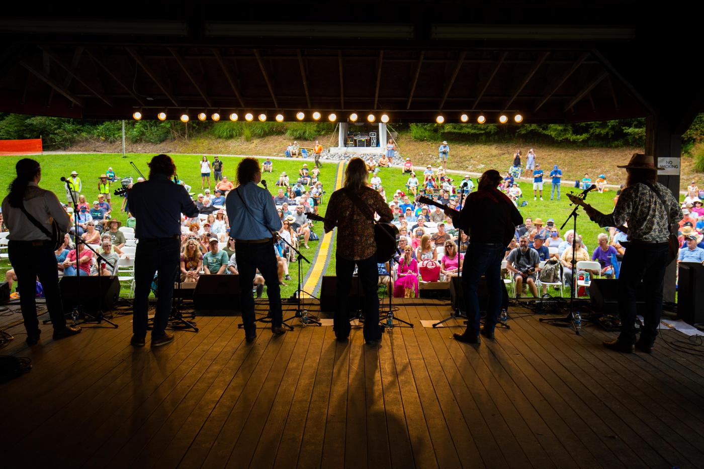 Performers on stage overlooking a crowd.