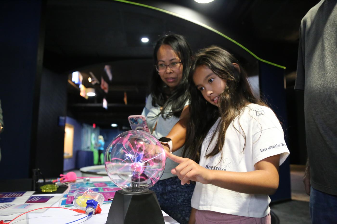 Aspiring scientist stops at the Duke Energy immersive exhibit at the Femme in STEM event hosted by the NC Aquarium at Fort Fisher.