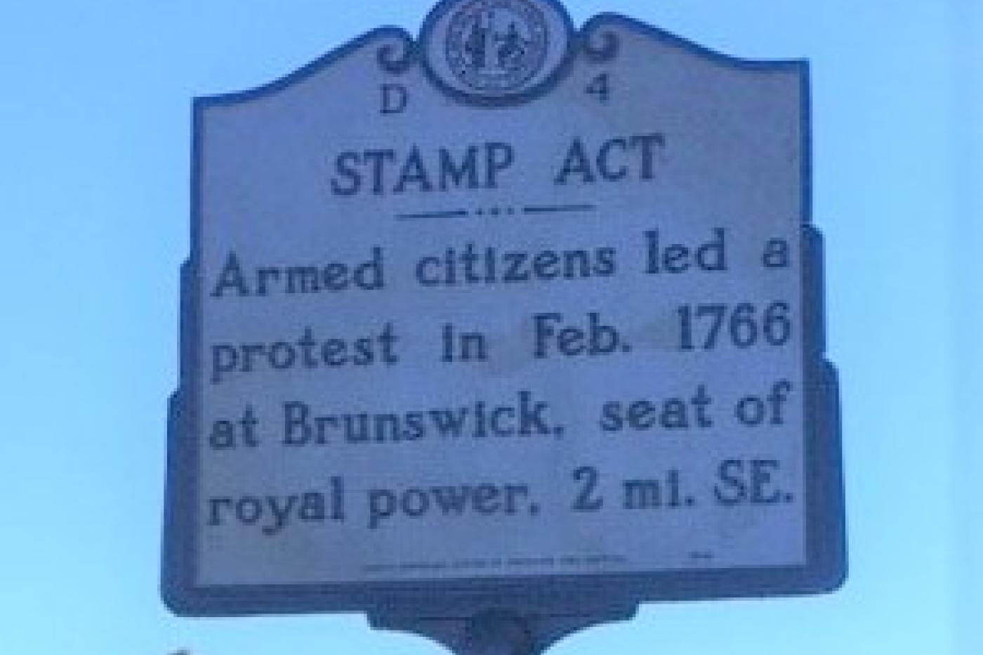 Historical marker reads: Stamp Act- Armed citizens led a protest in Feb. 1766 at Brunswick, seat of royal power, 2 mi. SE.