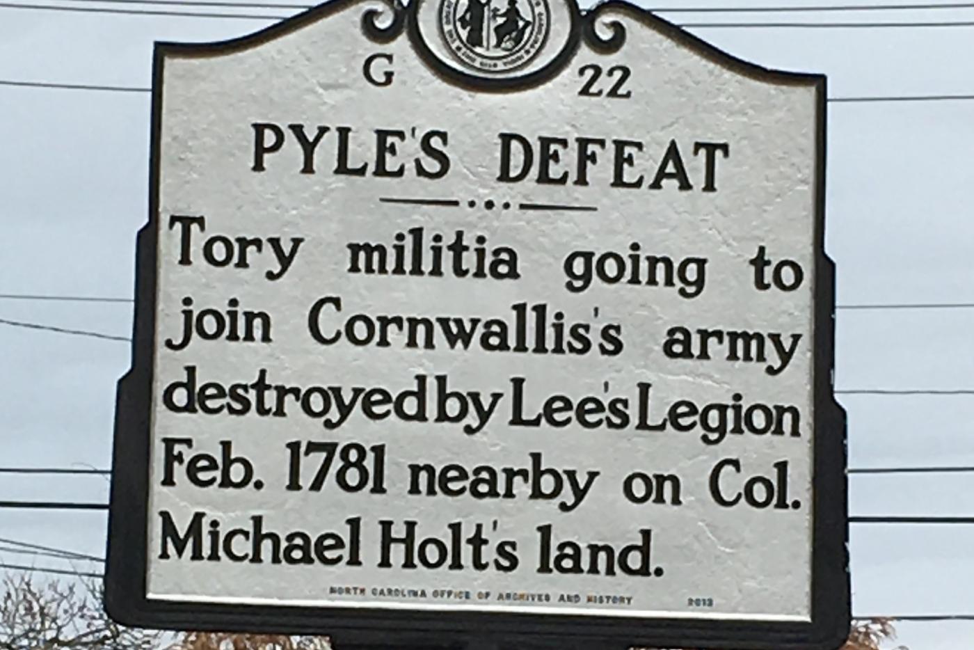 Historical marker heading reads: Pyles Defeat. Historical marker inscription reads: Tory militia going to join Cornwallis's army destroyed by Lee's Legion Feb. 1781 nearby on Col. Michael Holt's land.